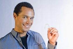 Man holding an invisalign clear aligner